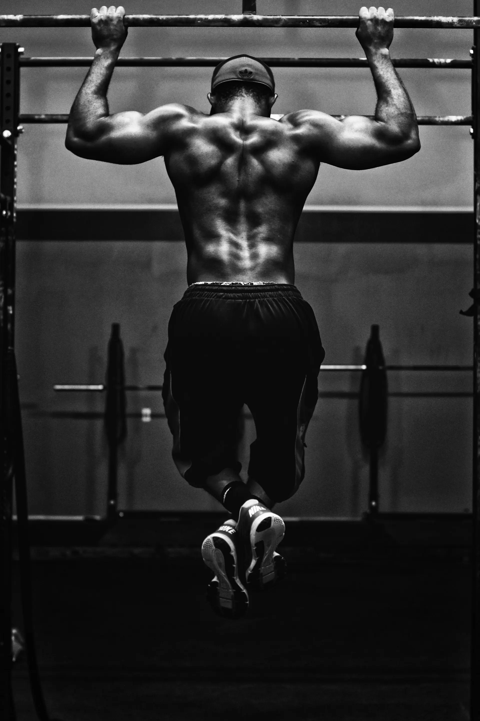 Athlete at the top of a heavy deadlift under chalk dust